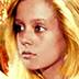 a young blonde undresses